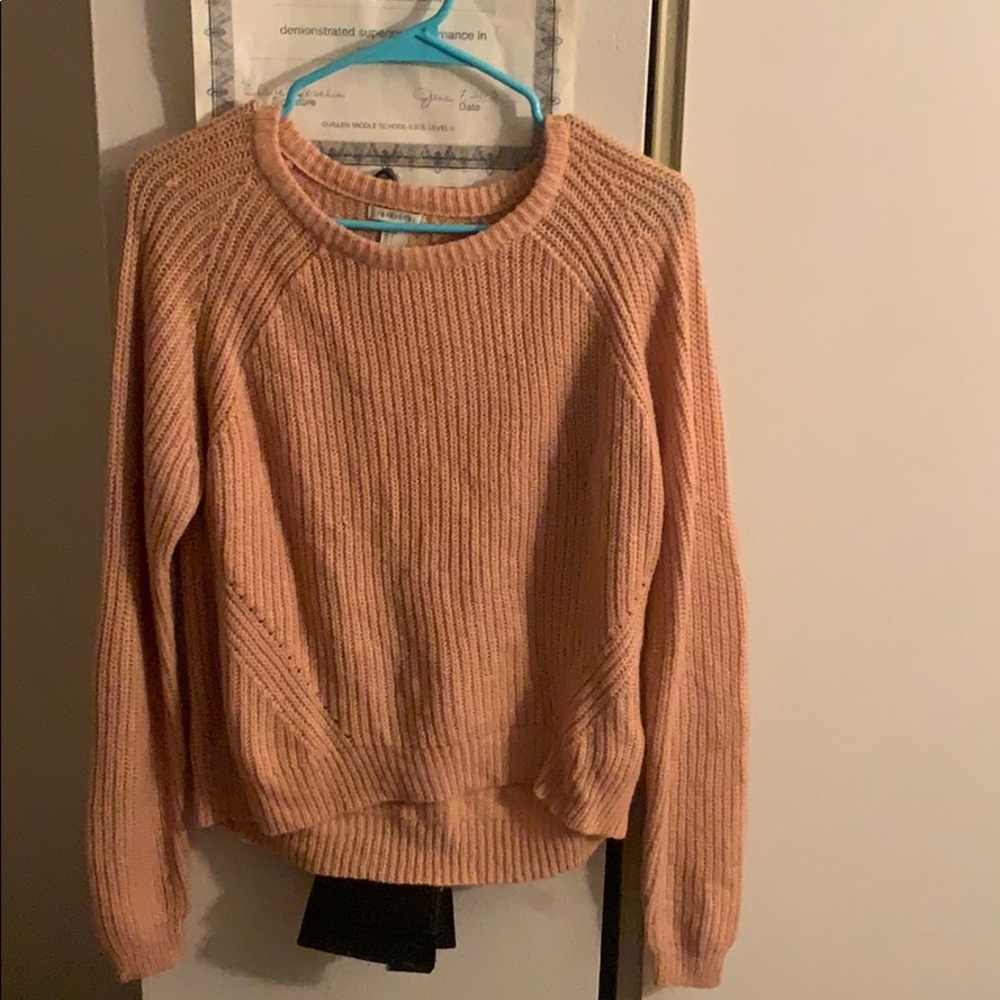 Sweater. The color of it it’s like peach.